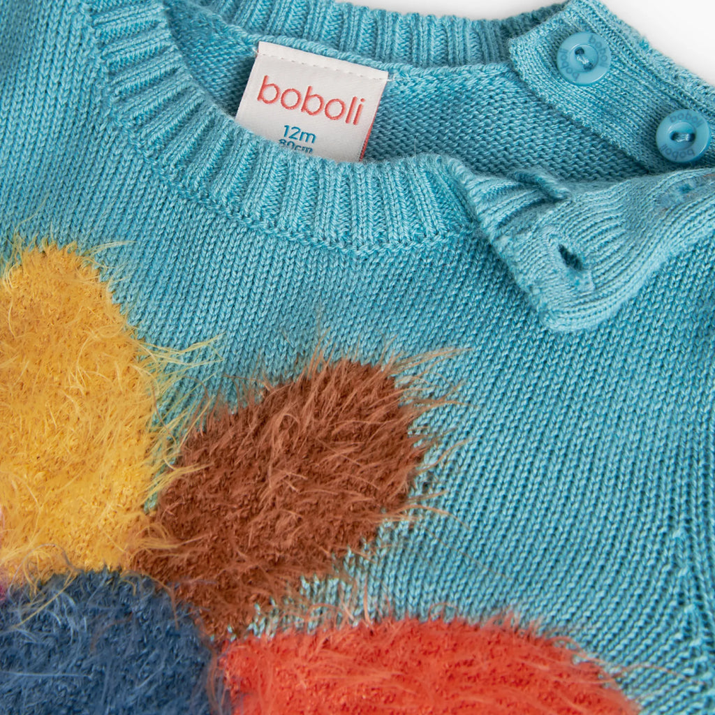 Maglione con fiore fondo turchese