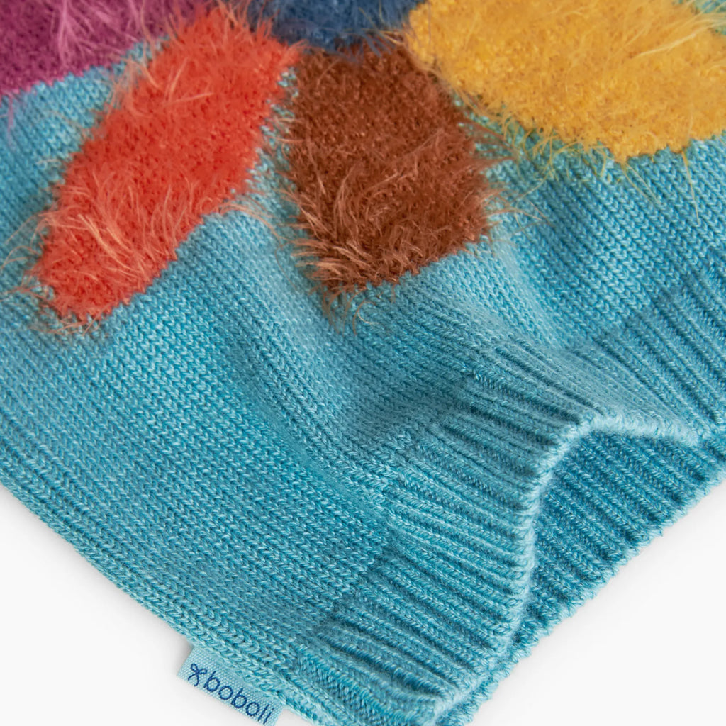 Maglione con fiore fondo turchese
